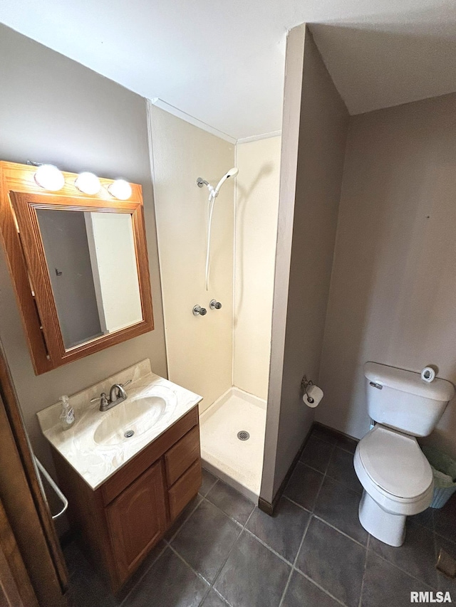 full bath featuring vanity, baseboards, a stall shower, tile patterned flooring, and toilet