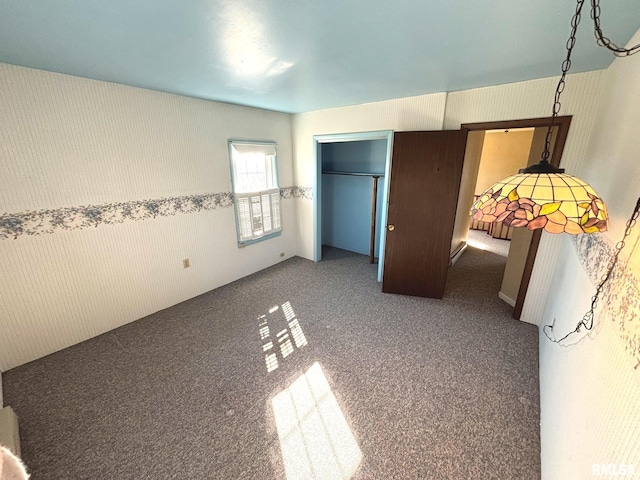 unfurnished bedroom with a closet and carpet floors