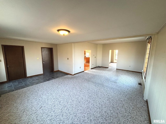 carpeted spare room with baseboards