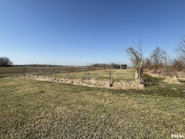 view of yard with a rural view and fence