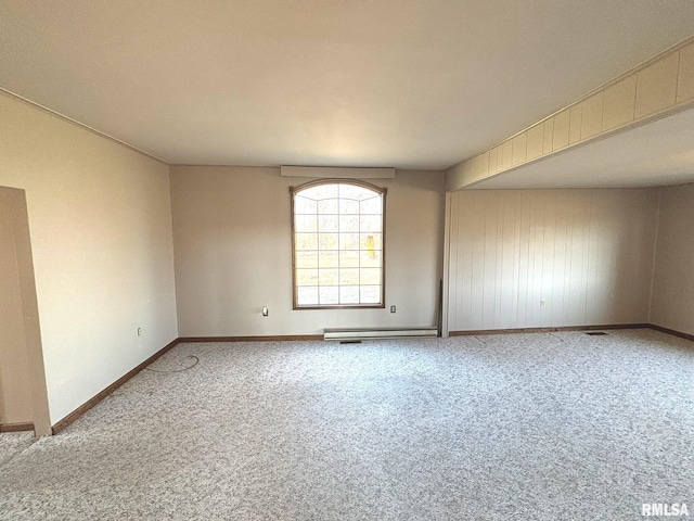 unfurnished room with carpet flooring, baseboards, and a baseboard radiator