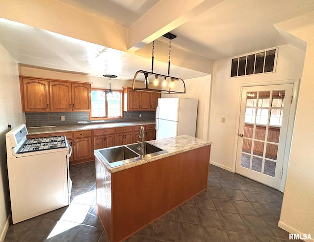 kitchen with brown cabinets, a sink, a center island, white appliances, and decorative backsplash