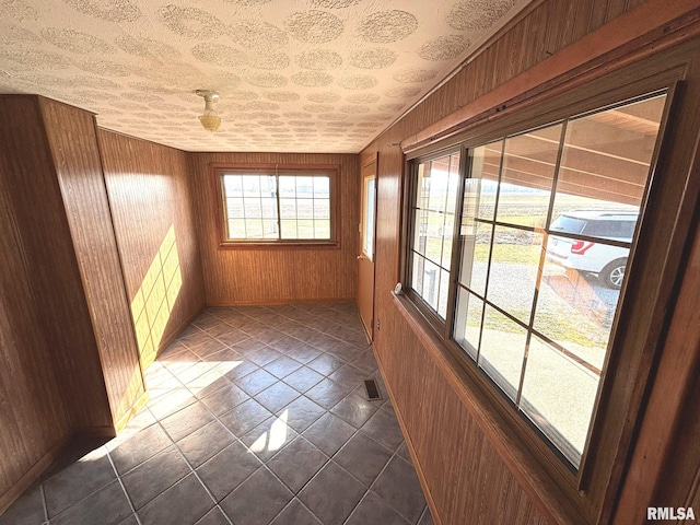 unfurnished sunroom featuring visible vents