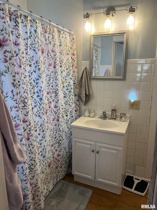 bathroom featuring tile walls, vanity, a shower with curtain, and wood finished floors