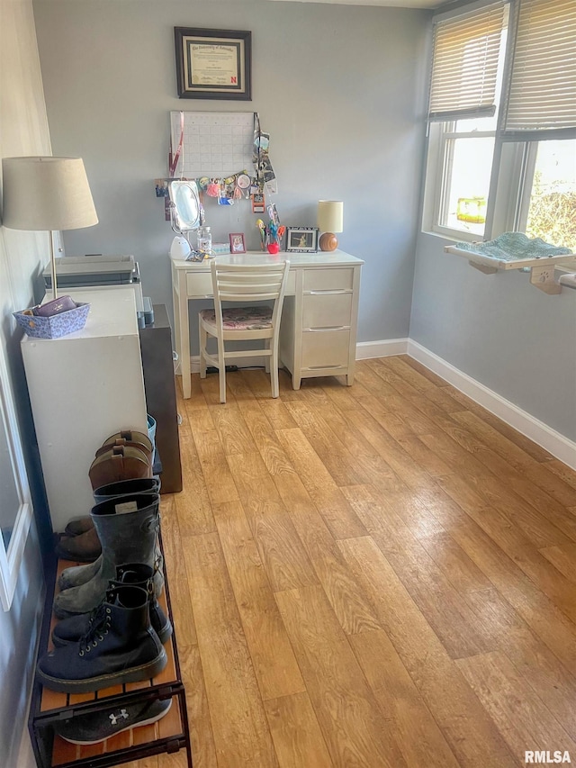 home office featuring baseboards and light wood-type flooring