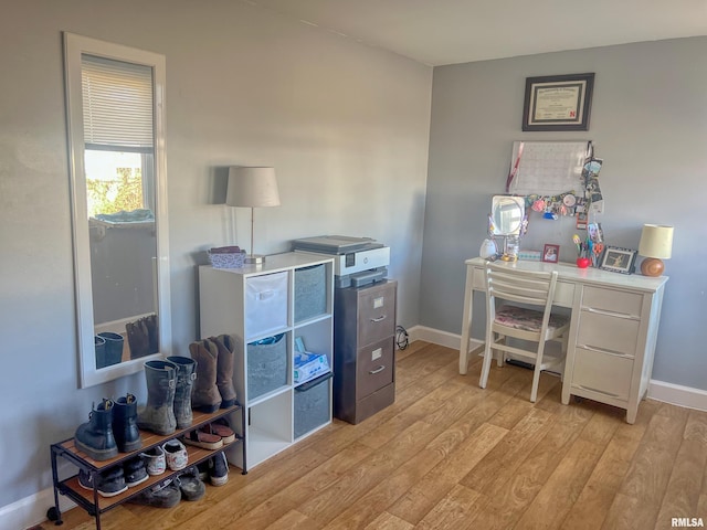 office area featuring baseboards and light wood-style flooring