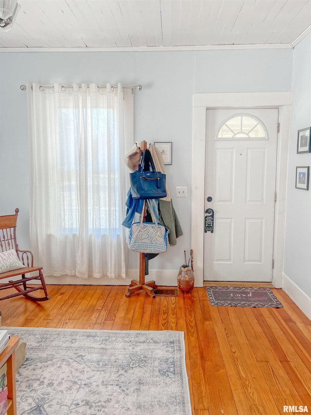 entrance foyer featuring crown molding and wood finished floors