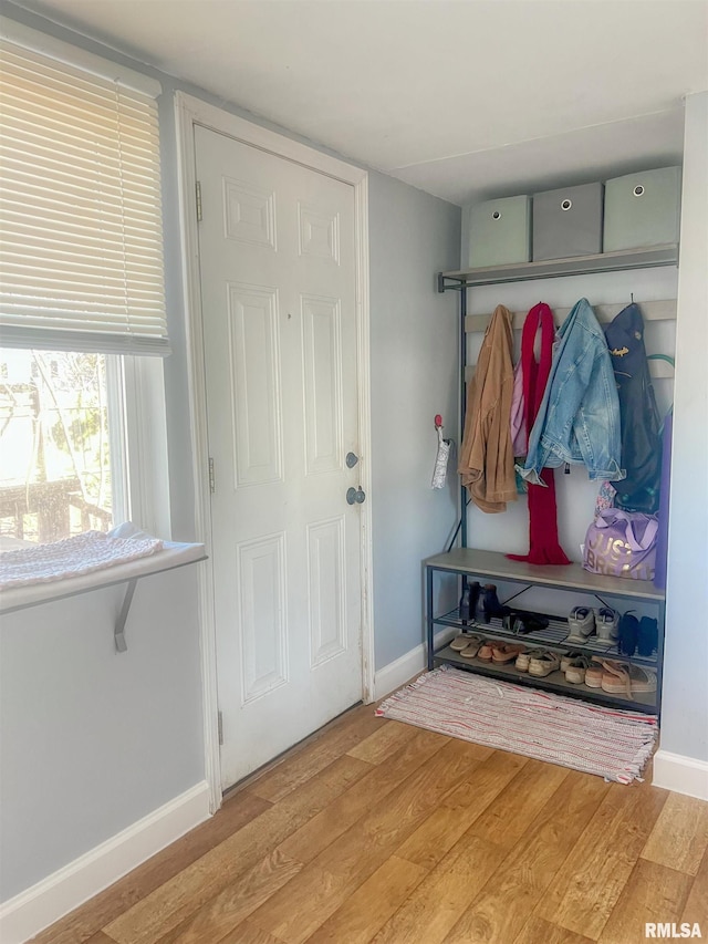 mudroom with light wood finished floors and baseboards