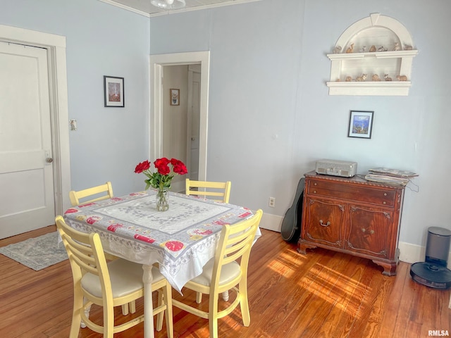 dining area featuring baseboards and wood finished floors