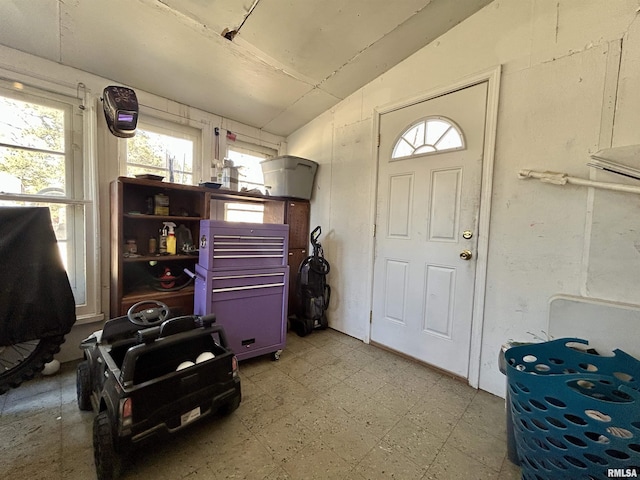 interior space with tile patterned floors and lofted ceiling