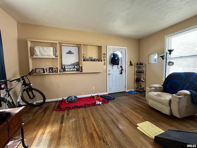 interior space with baseboards and wood finished floors