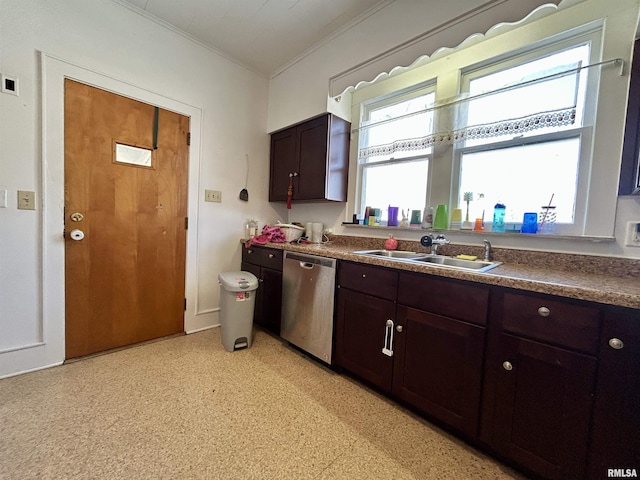 kitchen featuring a sink, dark countertops, stainless steel dishwasher, and dark brown cabinetry