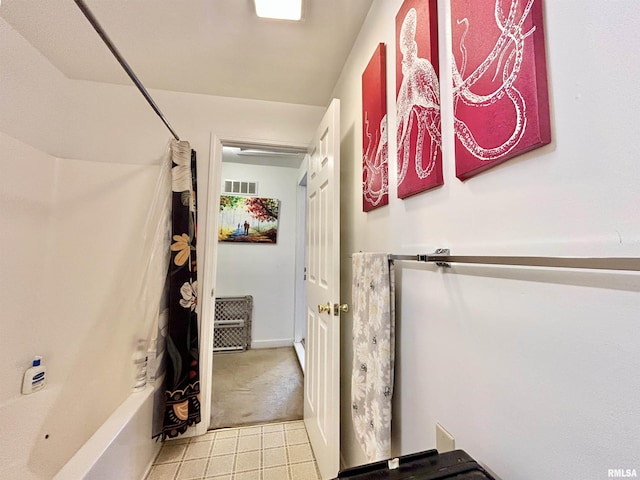 bathroom with visible vents and shower / bath combo with shower curtain