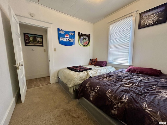 bedroom with baseboards and carpet floors