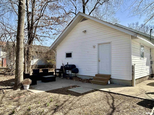 rear view of house with entry steps and a patio