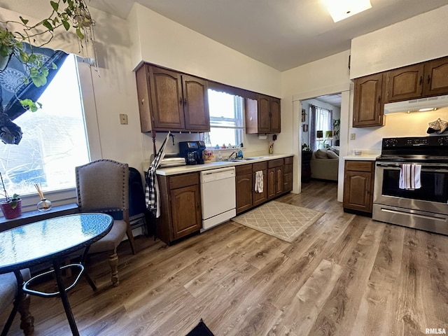 kitchen featuring under cabinet range hood, light countertops, electric stove, and white dishwasher