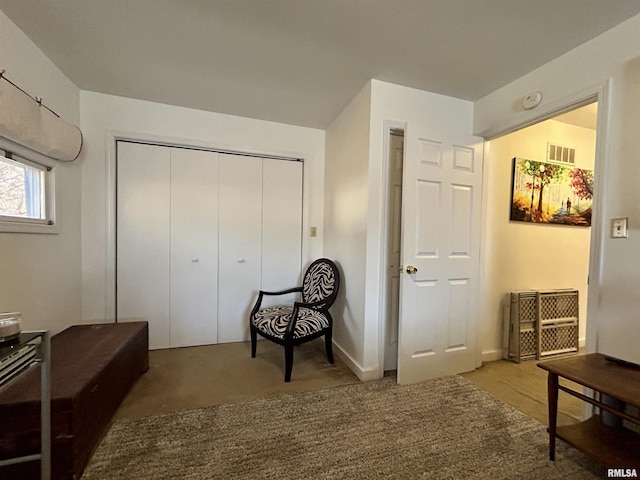 sitting room featuring carpet flooring and visible vents