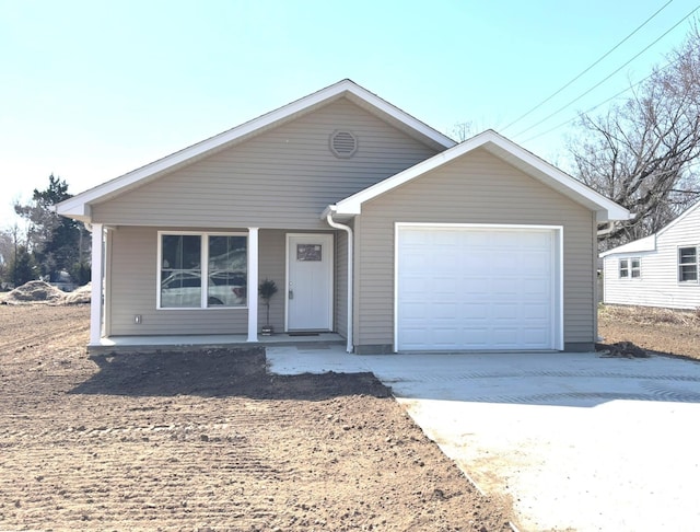 view of front of home with concrete driveway and a garage