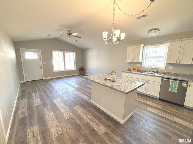 kitchen with visible vents, ceiling fan with notable chandelier, a sink, stainless steel dishwasher, and a center island