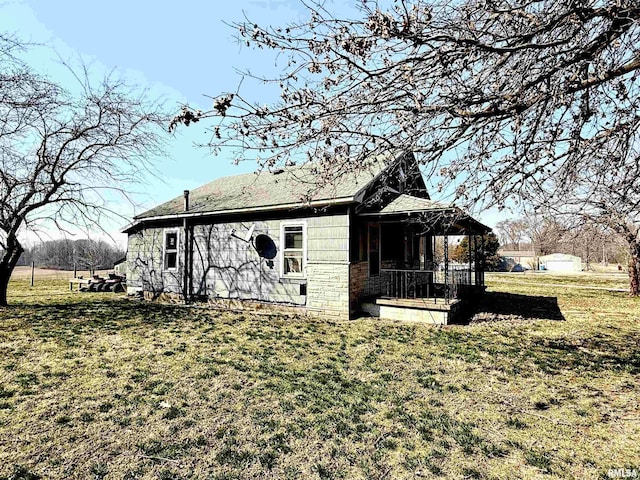 exterior space featuring a lawn and covered porch