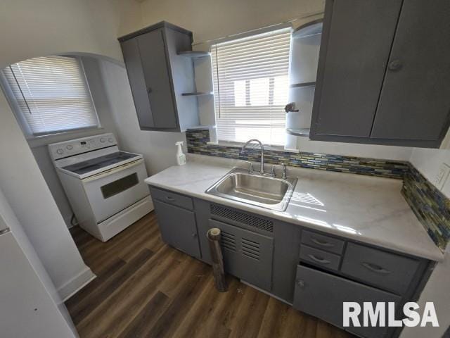 kitchen with white range with electric stovetop, gray cabinets, open shelves, and a sink