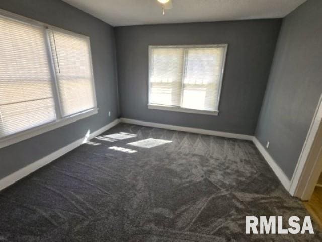 carpeted spare room with baseboards