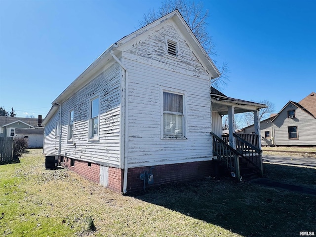 view of home's exterior with crawl space, a lawn, and cooling unit