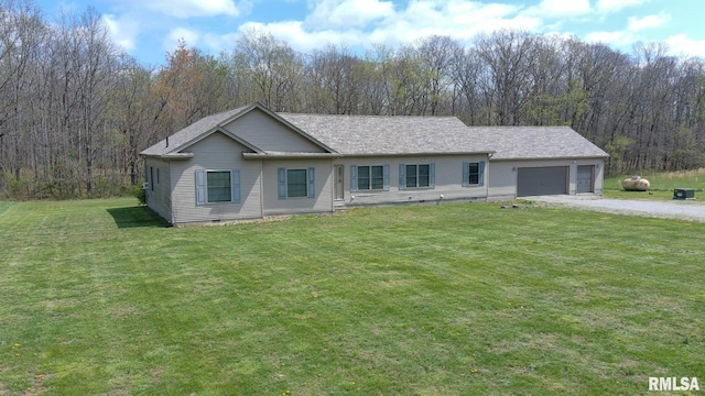 2814 Chouteau Ave, Odin, IL 62870 - ranch-style house featuring a front yard, an attached garage, crawl space, a forest view, and gravel driveway