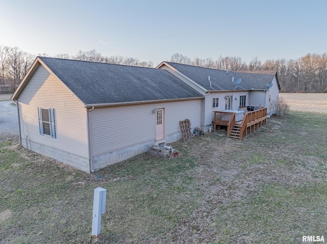 2814 Chouteau Ave, Odin, IL 62870 - rear view of house with a shingled roof, a deck, and a lawn
