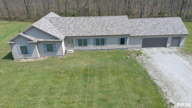 2814 Chouteau Ave, Odin, IL 62870 - single story home with a front yard, roof with shingles, an attached garage, and gravel driveway