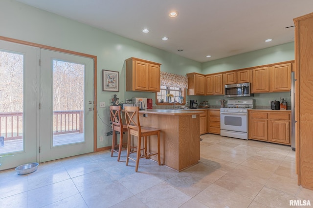 2814 Chouteau Ave, Odin, IL 62870 - kitchen featuring a breakfast bar area, recessed lighting, a peninsula, and stainless steel appliances