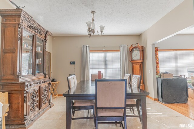 2814 Chouteau Ave, Odin, IL 62870 - dining area with a chandelier, a textured ceiling, baseboards, and a wealth of natural light