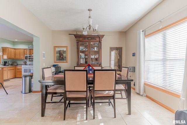 2814 Chouteau Ave, Odin, IL 62870 - dining area featuring baseboards, a chandelier, and a healthy amount of sunlight