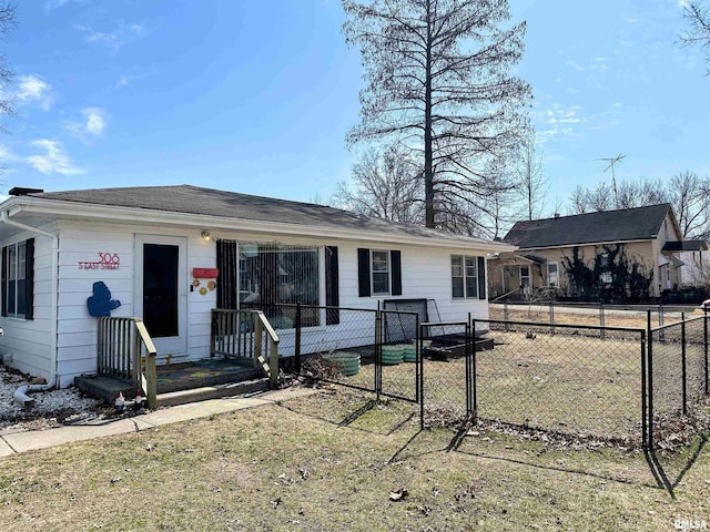 ranch-style home featuring a gate and fence