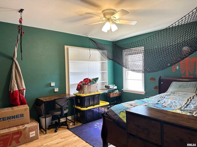 bedroom with wood finished floors and a ceiling fan