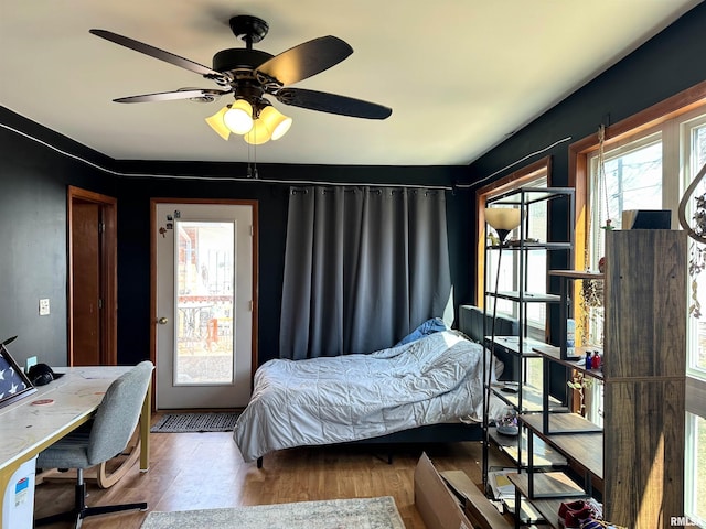 bedroom featuring a ceiling fan and wood finished floors