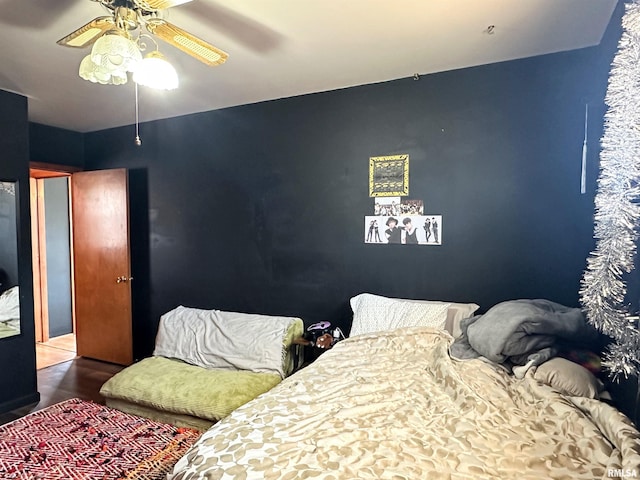 bedroom with wood finished floors and a ceiling fan