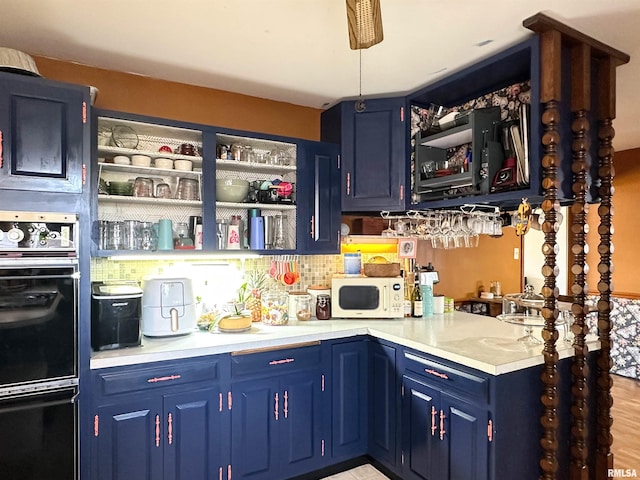 bar featuring white microwave, backsplash, and dobule oven black