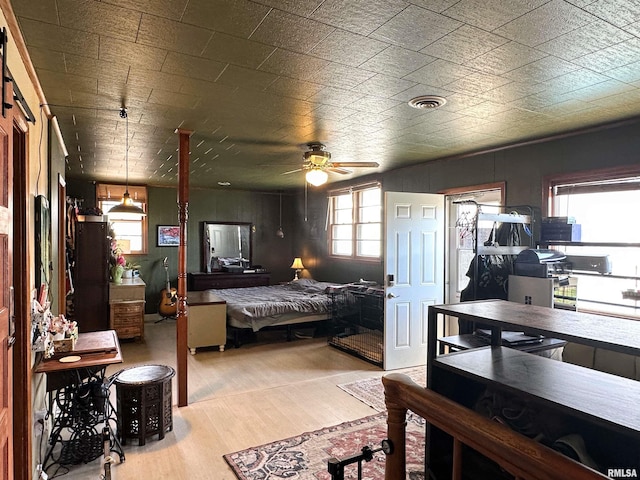 bedroom with visible vents and wood finished floors