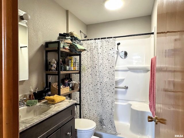 full bath featuring toilet, a stall shower, vanity, and a textured wall