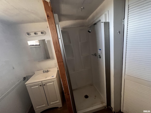 full bath with a stall shower and vanity