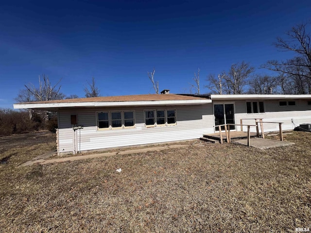 back of property with central AC