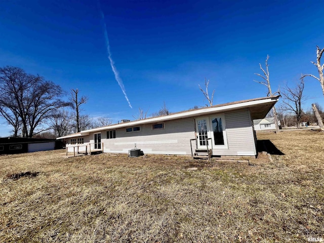 back of property featuring entry steps and central AC