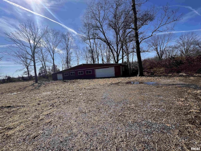 view of side of property featuring an outbuilding and an attached garage