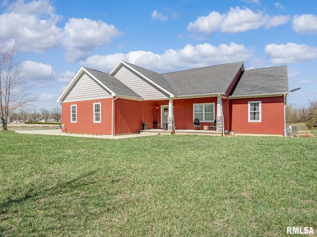 view of front of property featuring central AC unit and a front yard