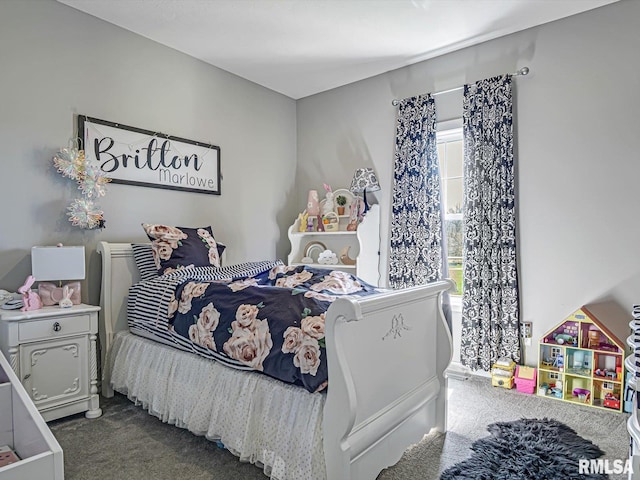 bedroom with dark colored carpet