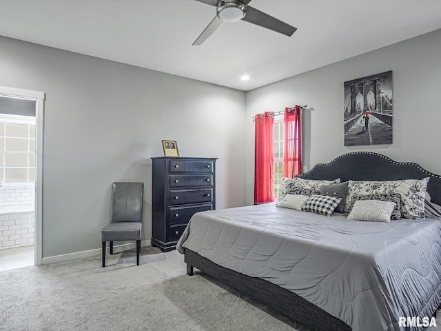 bedroom featuring ceiling fan, ensuite bath, baseboards, and carpet floors