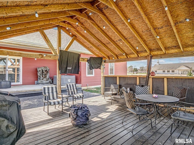 wooden deck featuring outdoor dining area