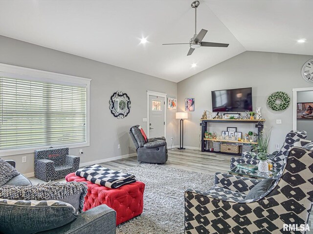 living area with wood finished floors, a ceiling fan, baseboards, recessed lighting, and vaulted ceiling