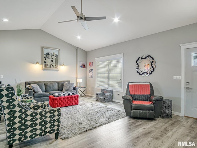 living room with baseboards, lofted ceiling, ceiling fan, and wood finished floors